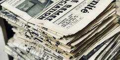 bundle-of-newspaper-on-table.jpg bundle of newspaper on table